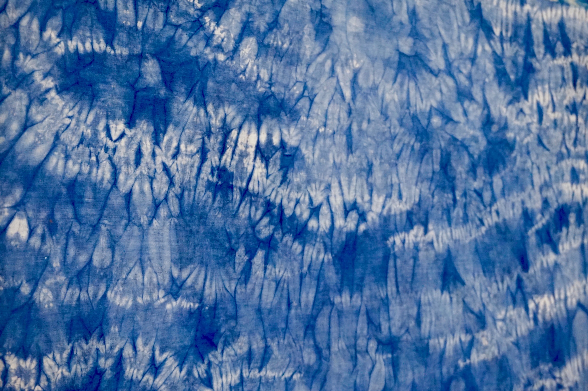 Repeating indigo dye pattern on cream background, created by Katrina Craig.